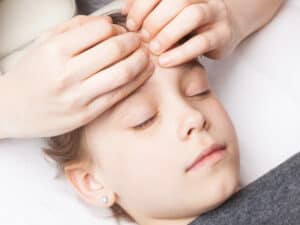 Kopf therapieren mit den Händen und Druck